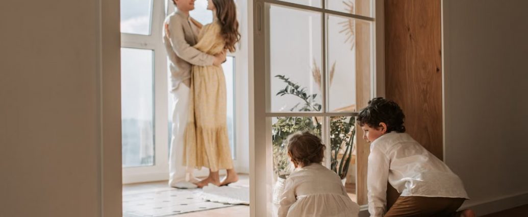 A joyful family moment indoors with parents and children enjoying a cozy home environment.