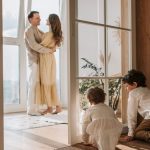 A joyful family moment indoors with parents and children enjoying a cozy home environment.